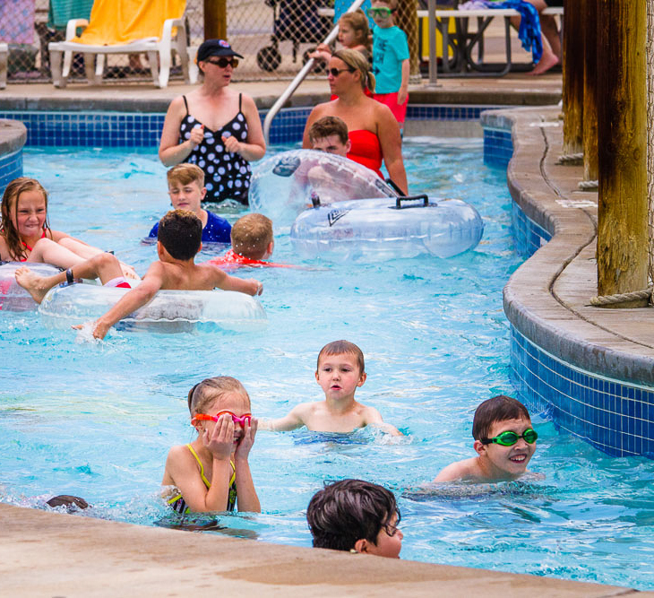 a group of children playing in Minnow creek